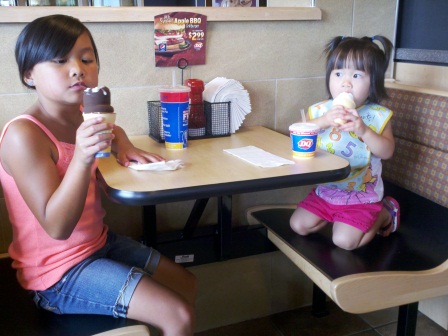 Kasen and Karis eating ice cream cones at Dairy Queen